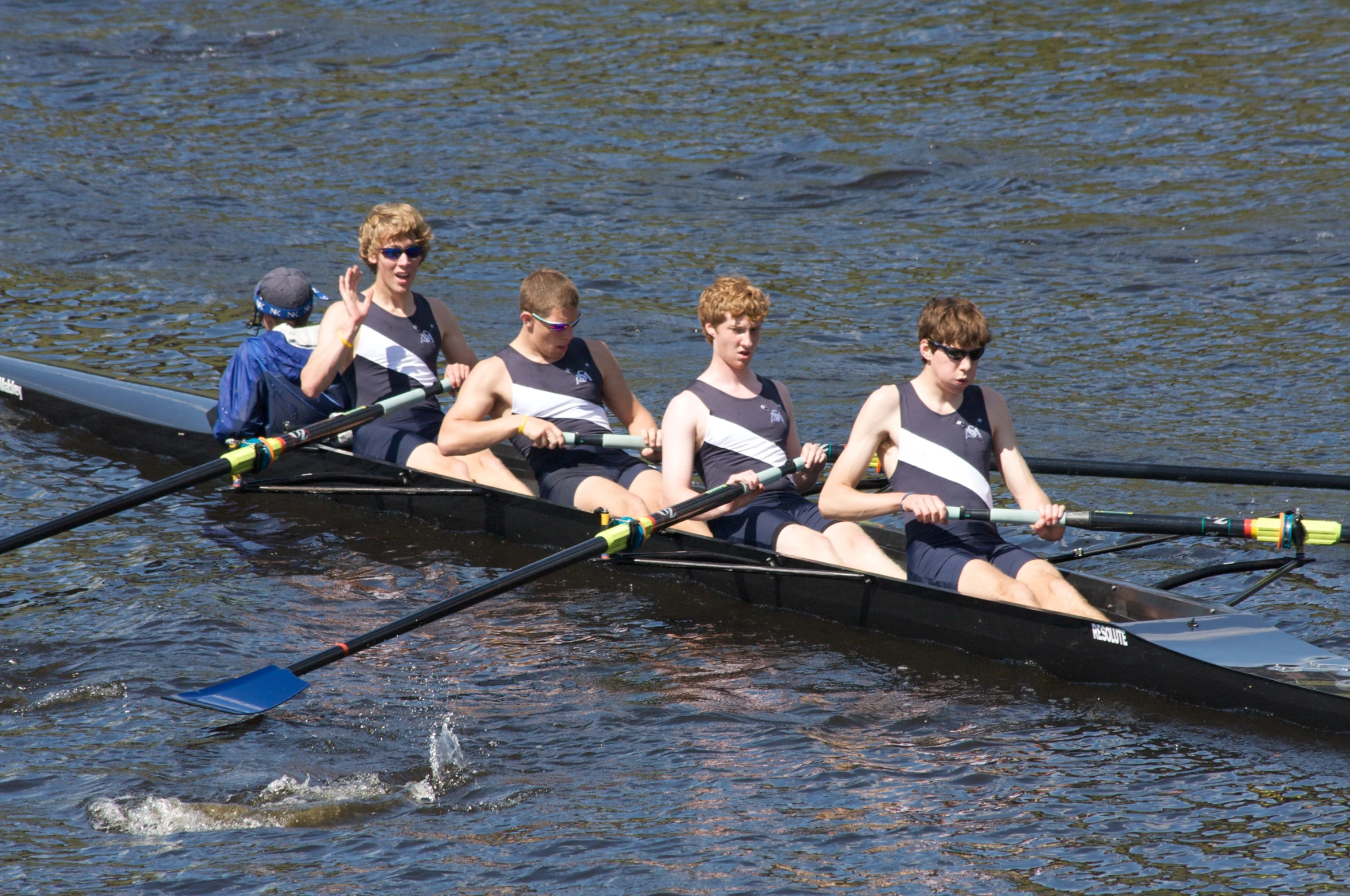 some boys are rowing and posing for the camera