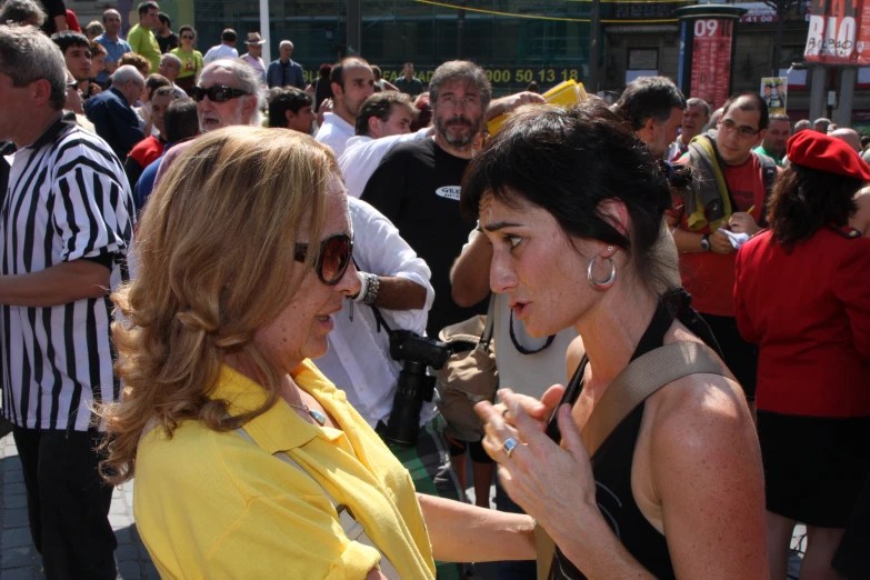 a woman with her hand on another woman's shoulder