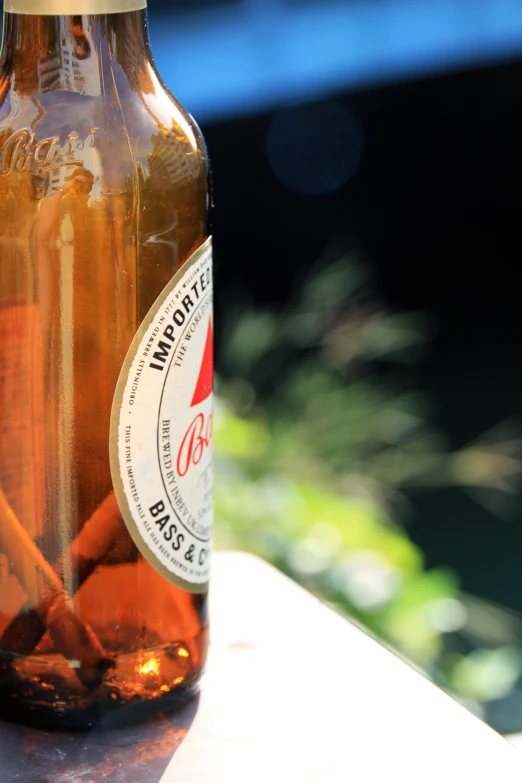 a glass beer bottle with some paper wrapped in some brown stuff