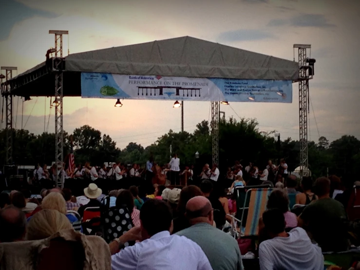 a number of people on chairs at an event