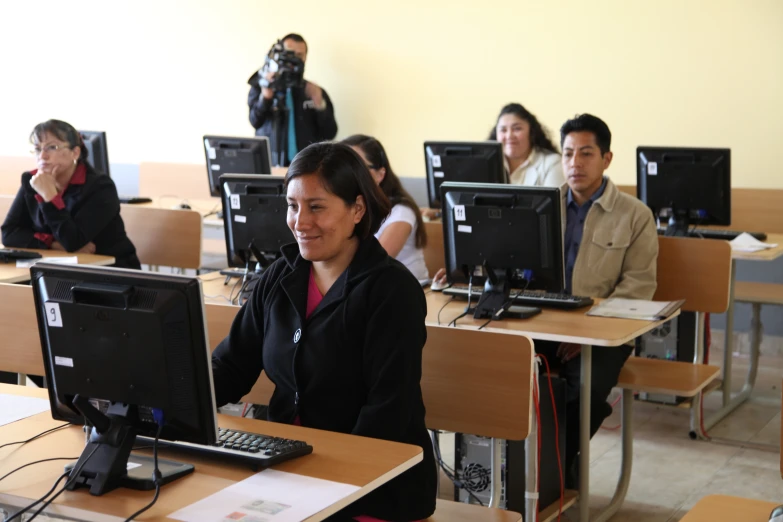 people are all working on computers in a classroom