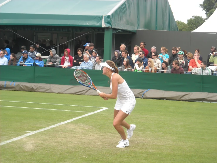 a woman holding a tennis racket on a court