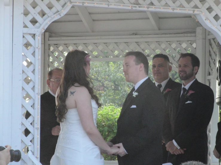 two men are shaking hands at the wedding