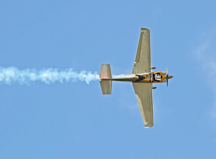 an orange and gray airplane is flying in the sky