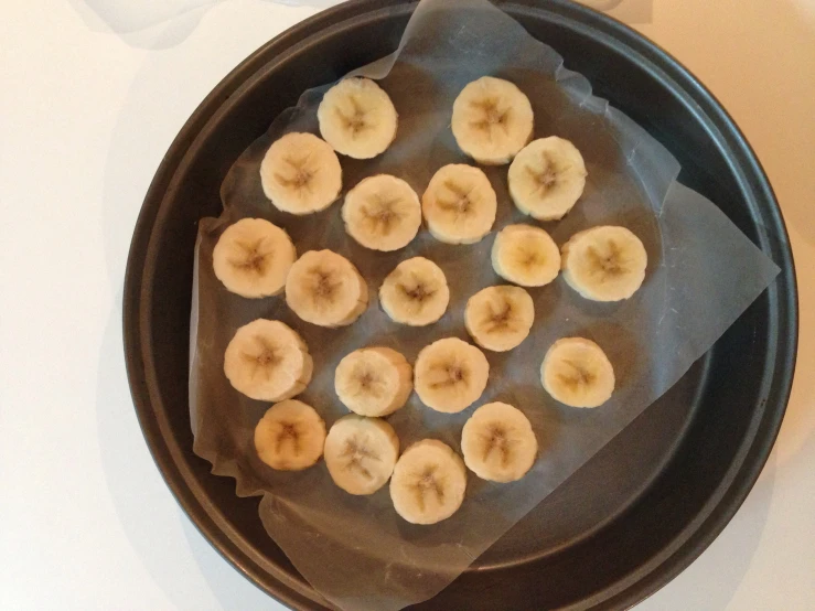 a plate filled with sliced banana's sitting on a counter top