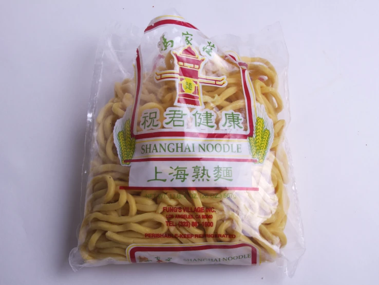 packaged chinese noodles in plastic wrap with red and white writing