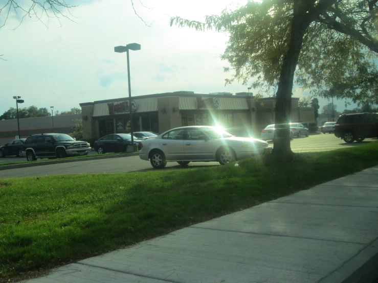 an intersection with parking spaces is pictured in the foreground