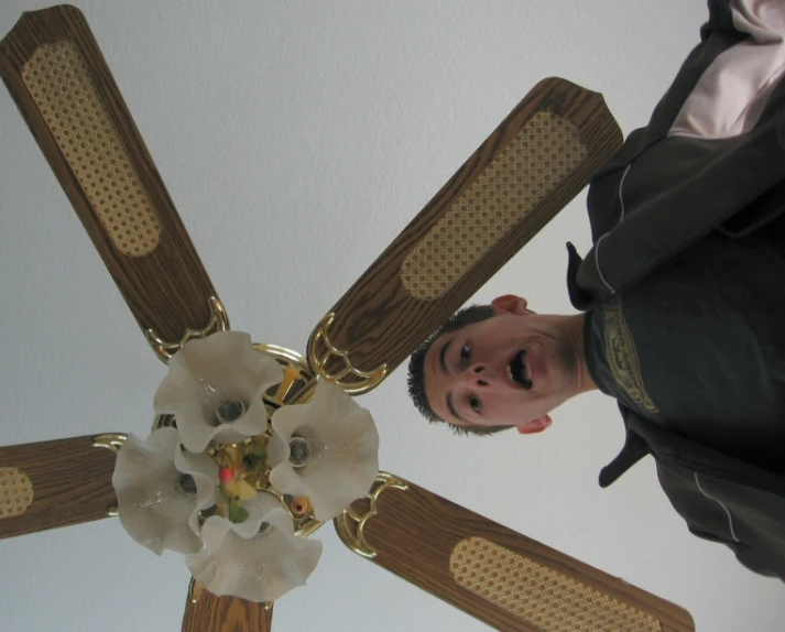a ceiling fan with two flowers attached to it
