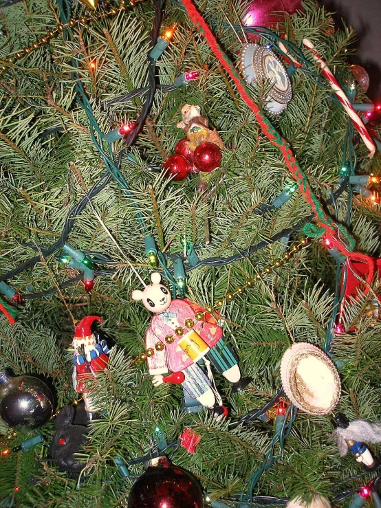 a christmas tree decorated with ornaments and tinsel