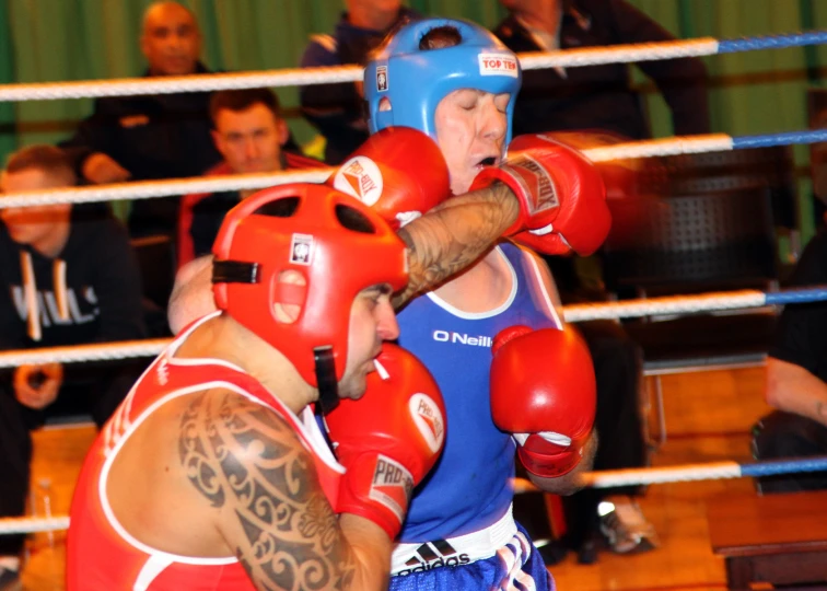 a guy on a knees throws the boxing bag to another