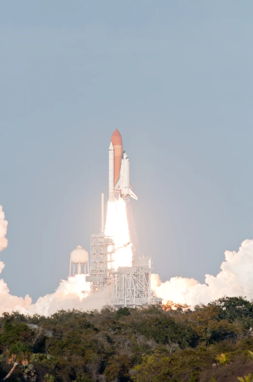 a large space rocket is lifting off into the sky