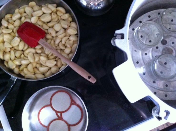 two pans sitting on the stove with nuts in them