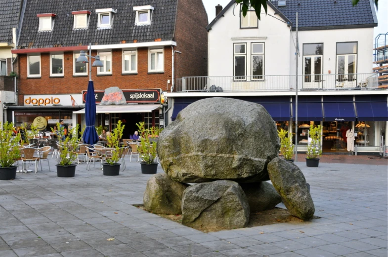 a rock sitting on top of a cement ground