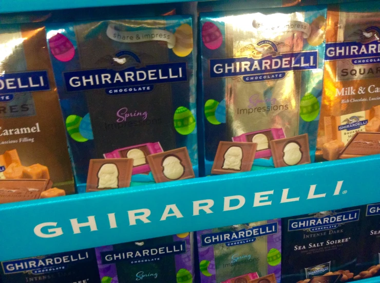 three packages of ghirardelli chocolate on display