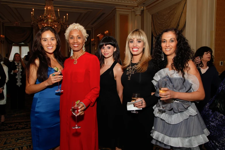 a group of women smiling and standing together