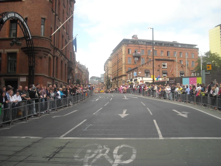 a crowd of people is gathering at the side of a street