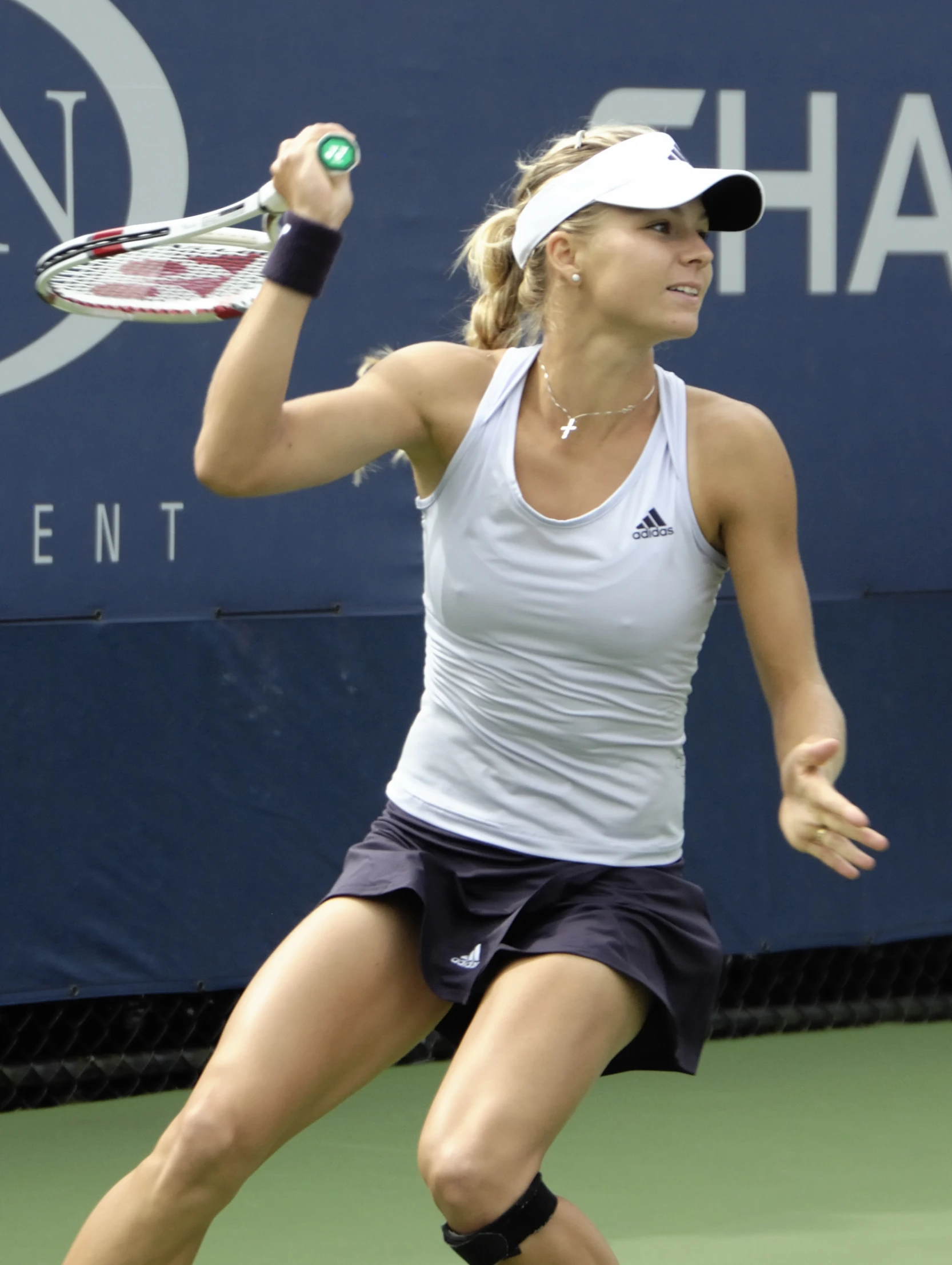 a lady standing on a court holding a tennis racket