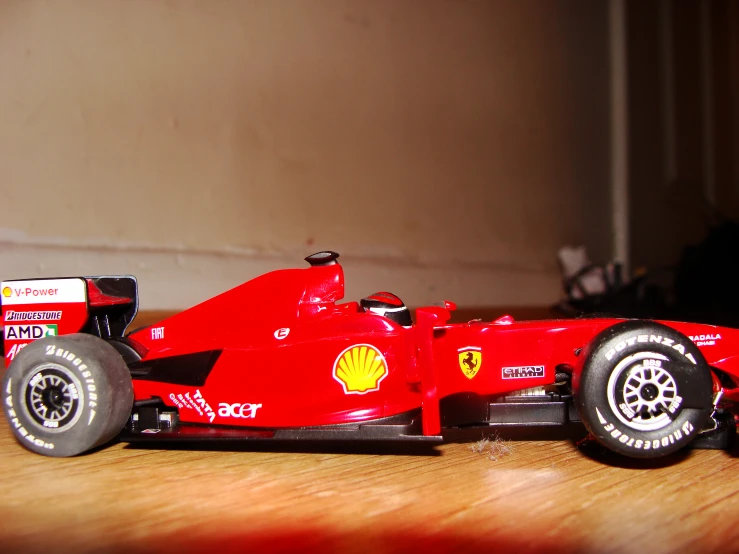 a toy racing car sitting on top of a wooden table