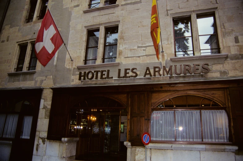 the building is very tall with the flags around it