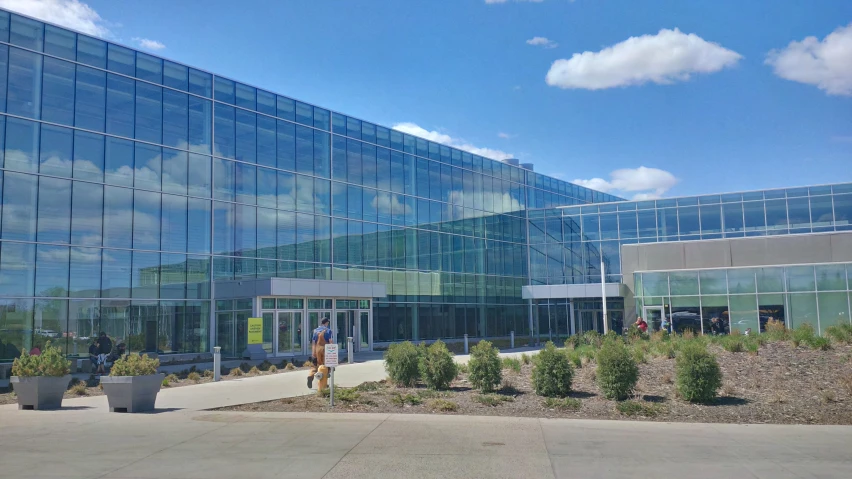 an image of a man walking by a building