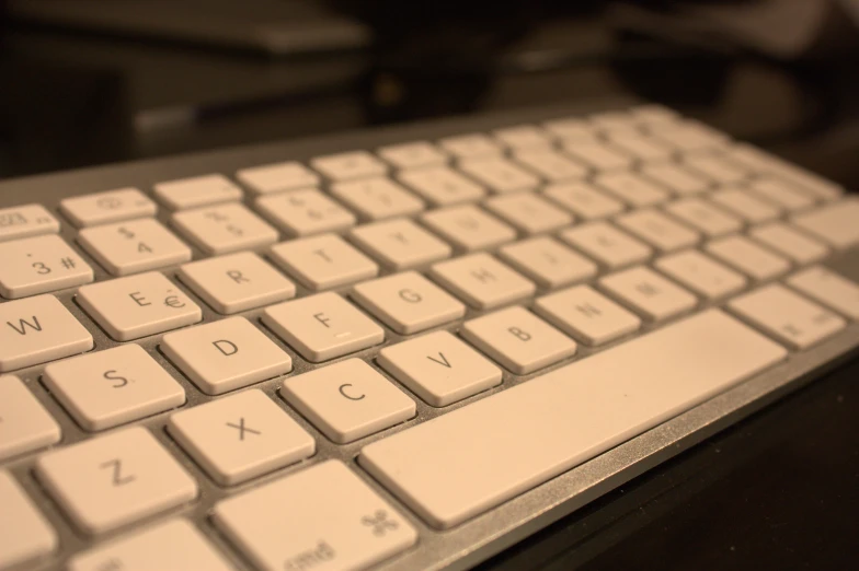 a close up of the backlit keyboard on an apple computer