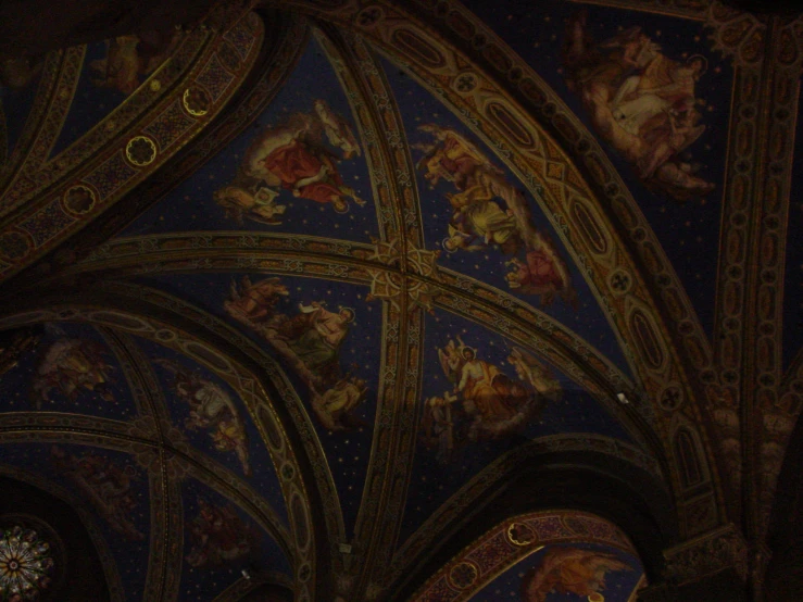 a ceiling in the church is decorated with many decorative paintings