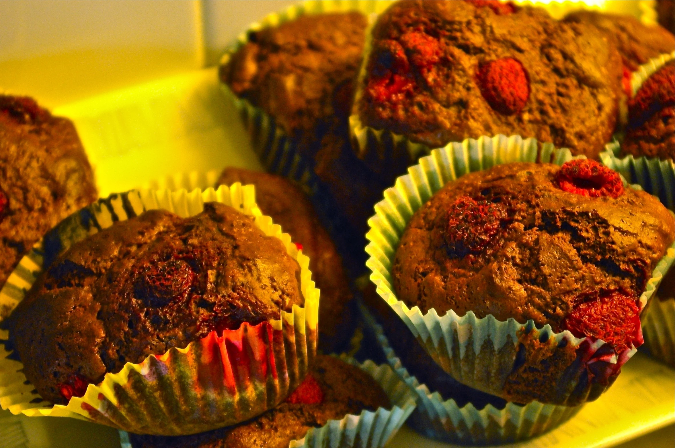 several muffins with fresh strawberries in them