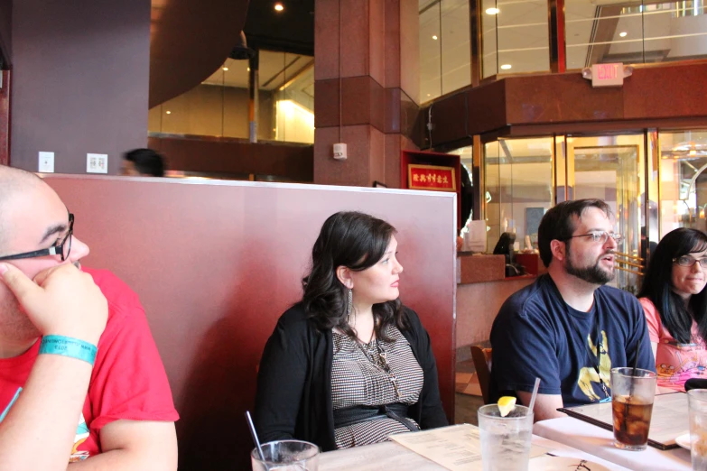 several people in a restaurant with many drinks