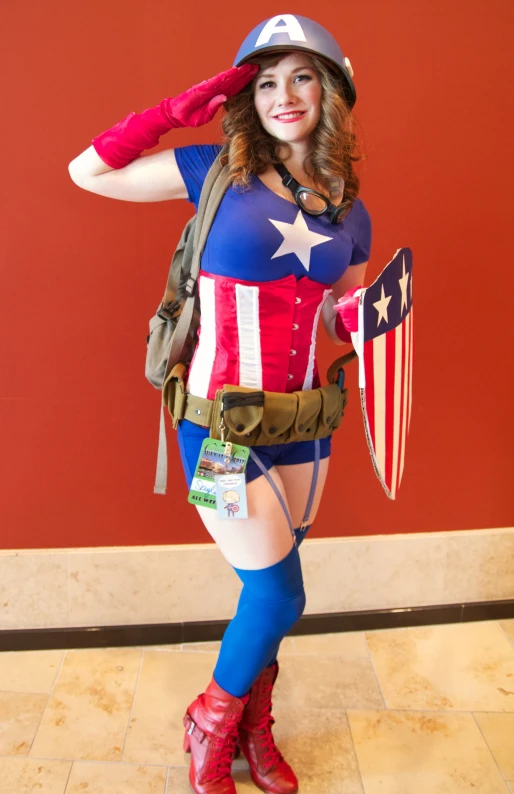 a girl dressed in a costume with american flag and flag on her shoulders