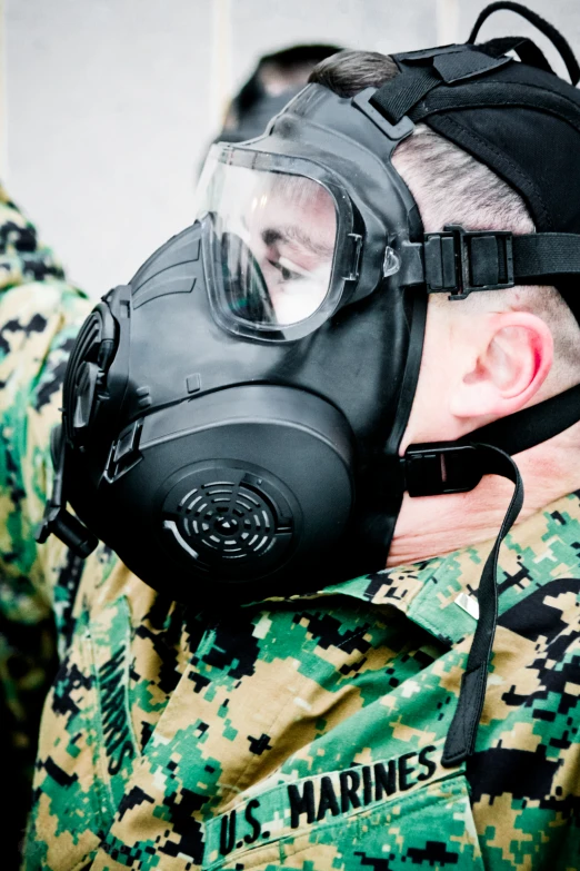 soldier wearing black and green gas mask
