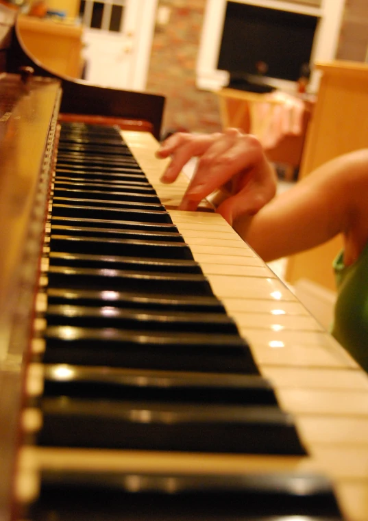 someone playing a piano with a small remote control