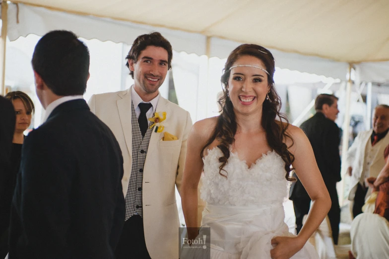 the bride is talking to a guest in a wedding party