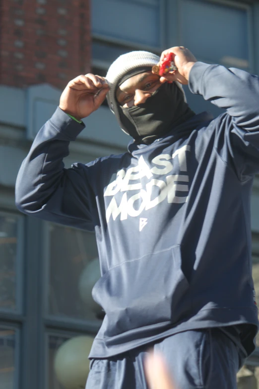 a man in a black mask holding a red object