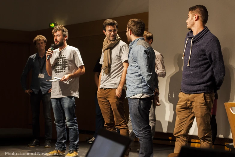 several young men standing around and looking at soing