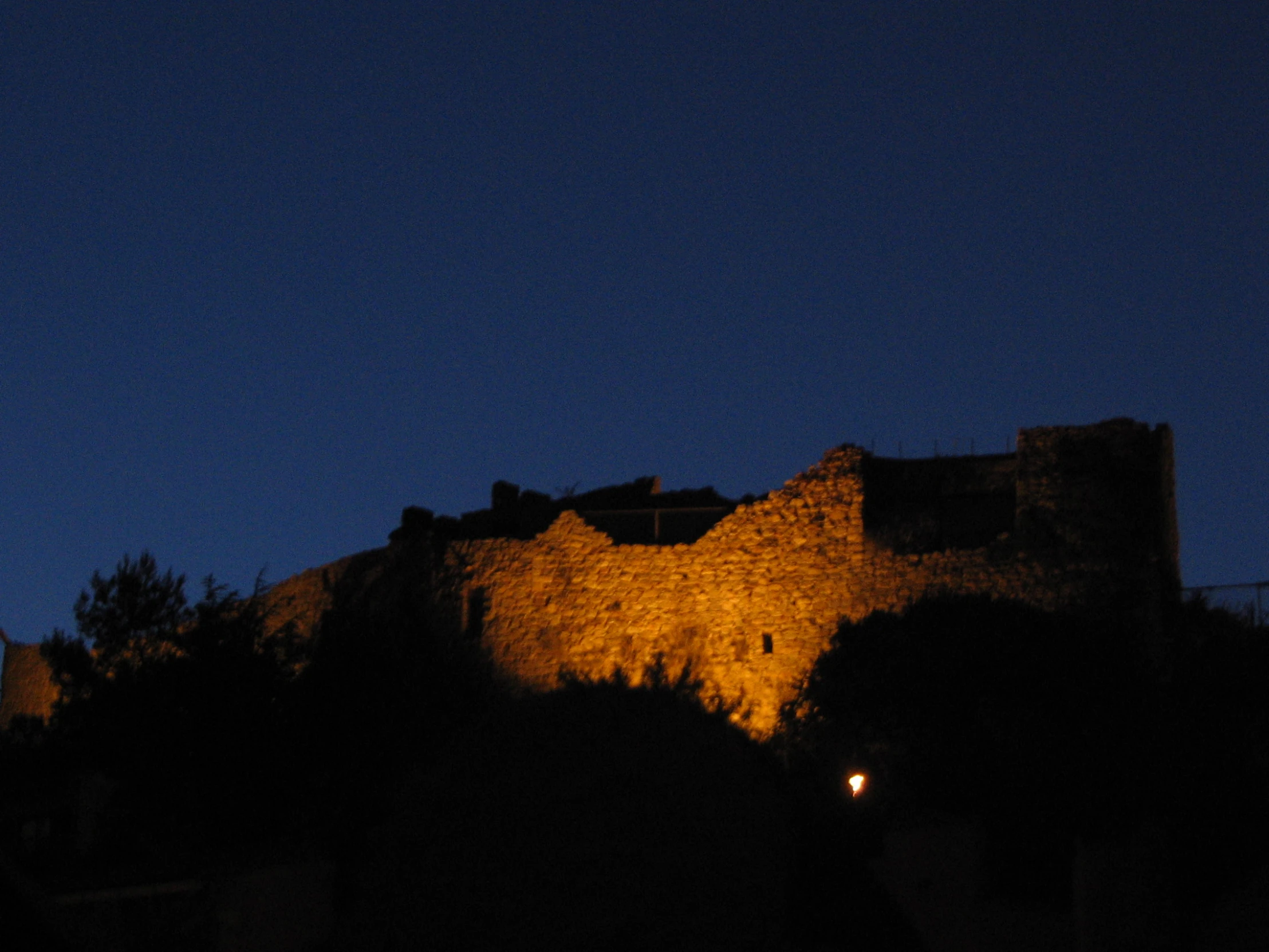 a castle with towers lit up at night