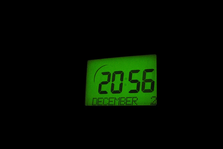 a clock in the dark showing 2 55pm
