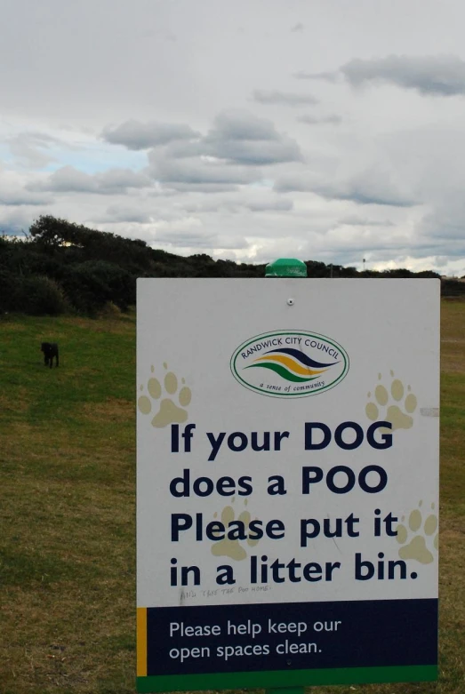 sign in a field telling the dogs to put litter into the water