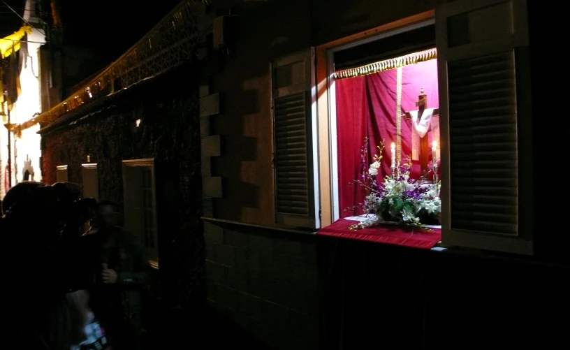 a flower shop is decorated with red curtains