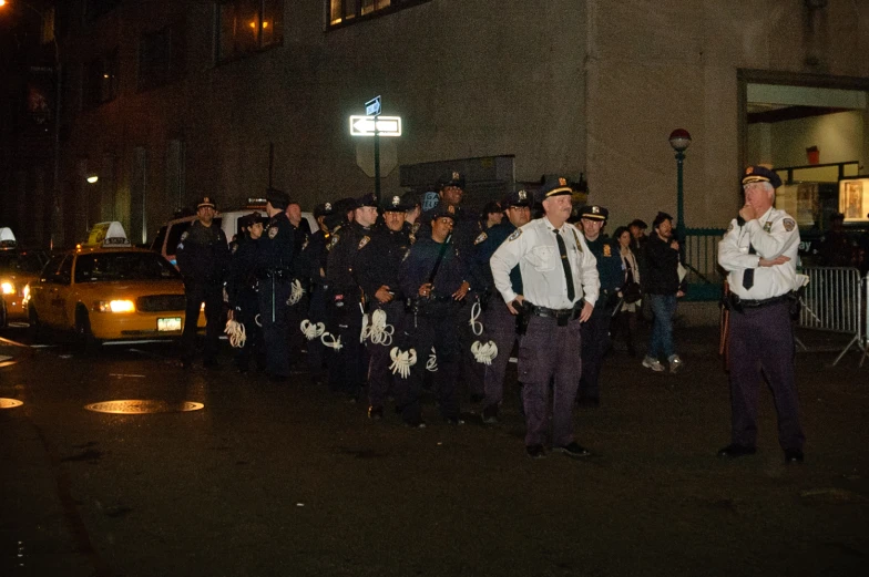 there are several police officers walking in line