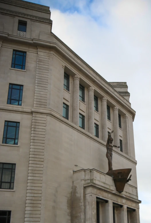 a stone building with a statue on the front