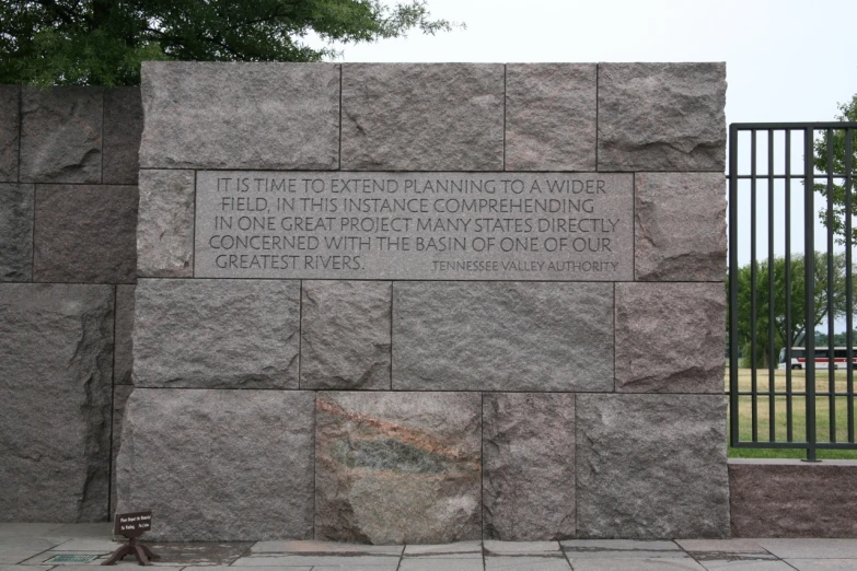 a brick wall has a plaque on it