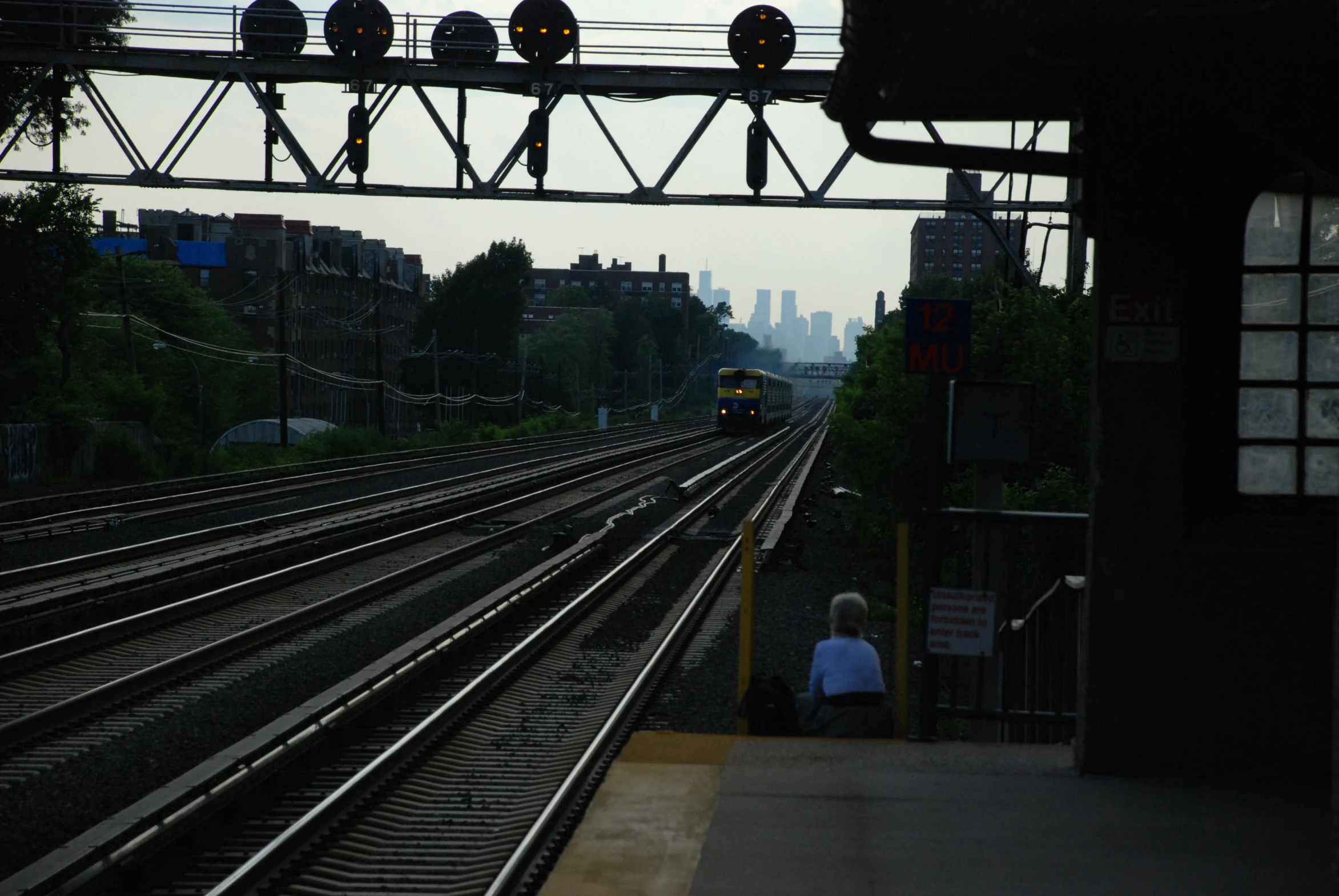 a person waiting on the platform at an intersection