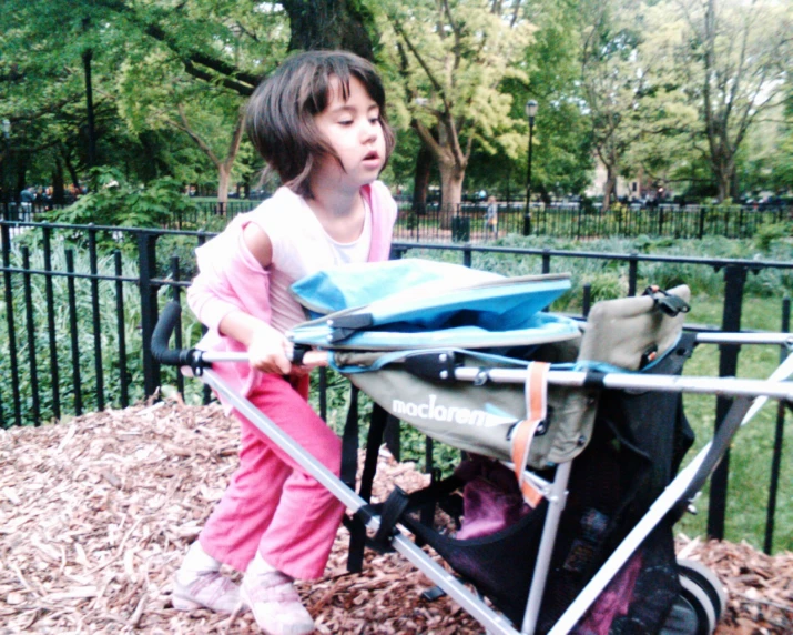  hing a stroller and holding a piece of blue fabric