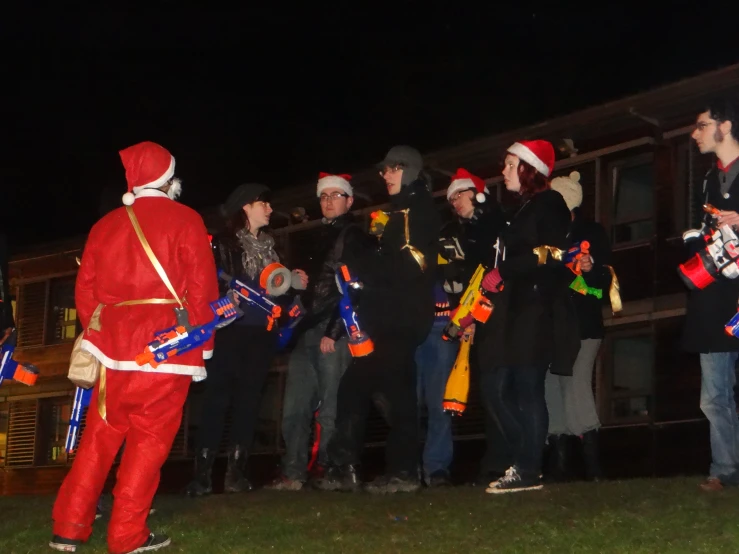 a group of people wearing christmas clothes at night