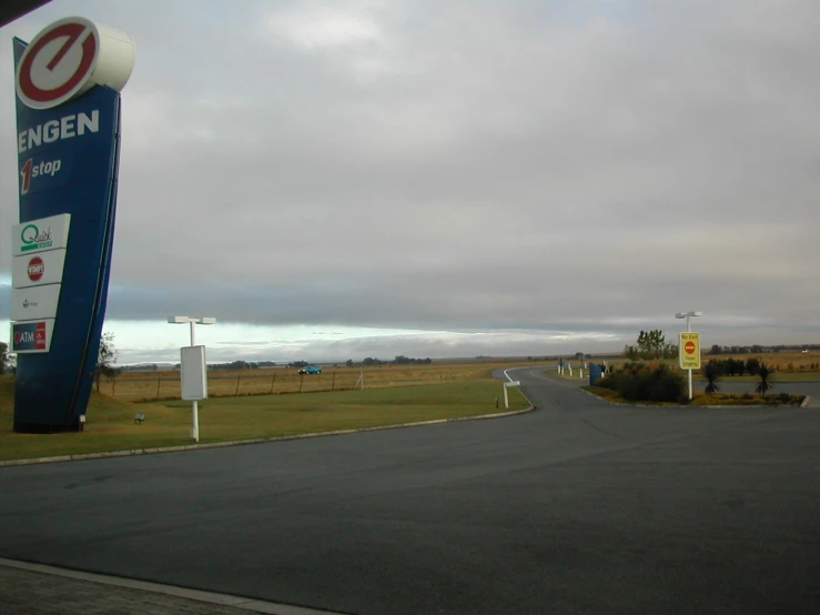 a gas station sits in the midst of a grassy area