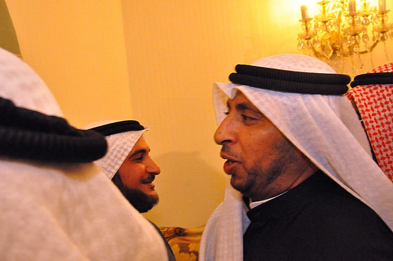 two men in headdress are talking to each other