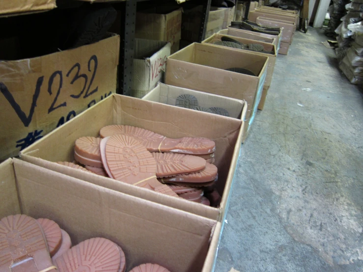 some boxes with some different kinds of pink cookies in them