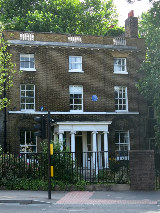 a large building with some tall windows and an iron gate