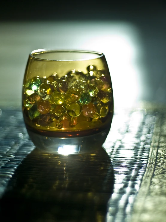 a vase is filled with yellow jewels on the table