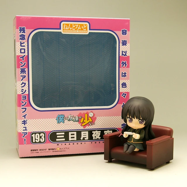 there is a little anime figure sitting next to an old box